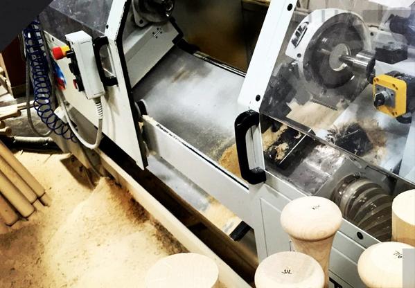 2-axis CNC wood lathe turning a wooden baseball bat blank